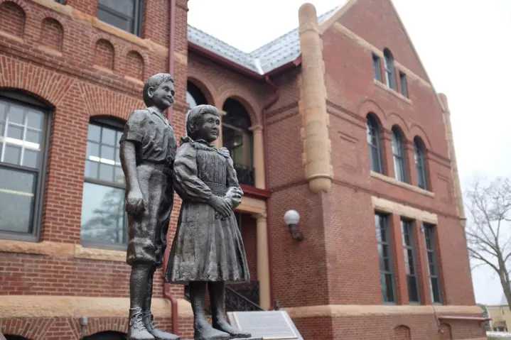 A photo of a statue in front of the main West Hills building